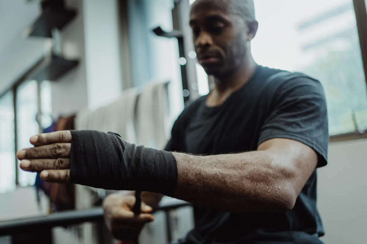 A fighter wrapping his hands before training