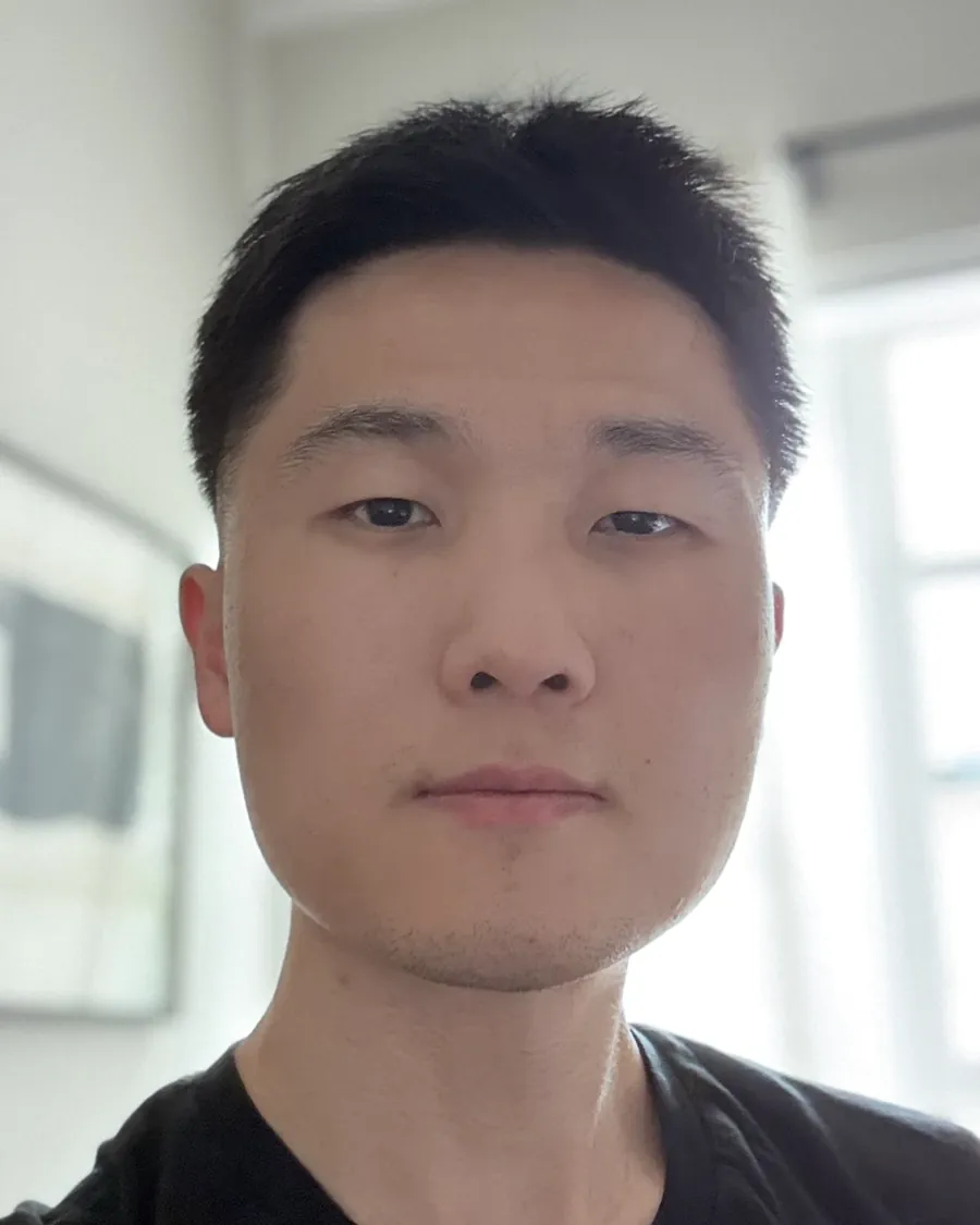 Portrait of Floyd Xiao, sports mental and performance coach, looking directly at the camera